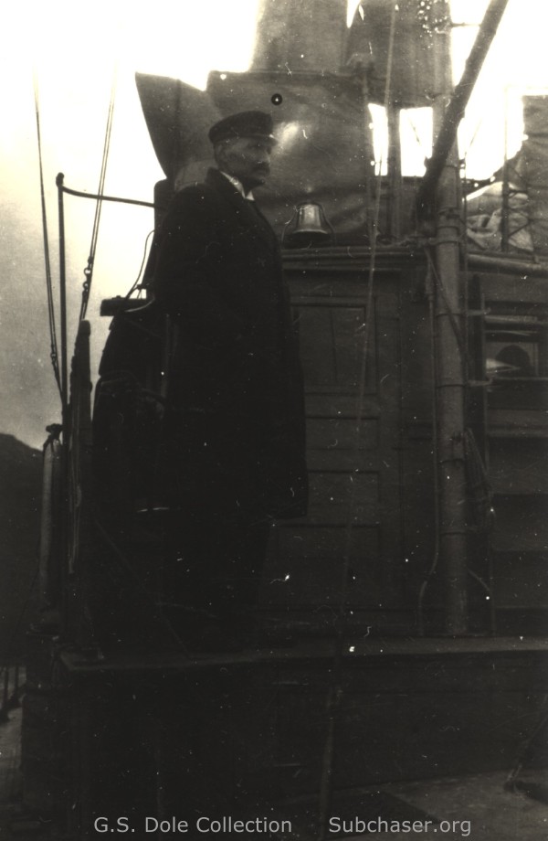 Officer on bridge wing and bell displayed on the flying bridge.